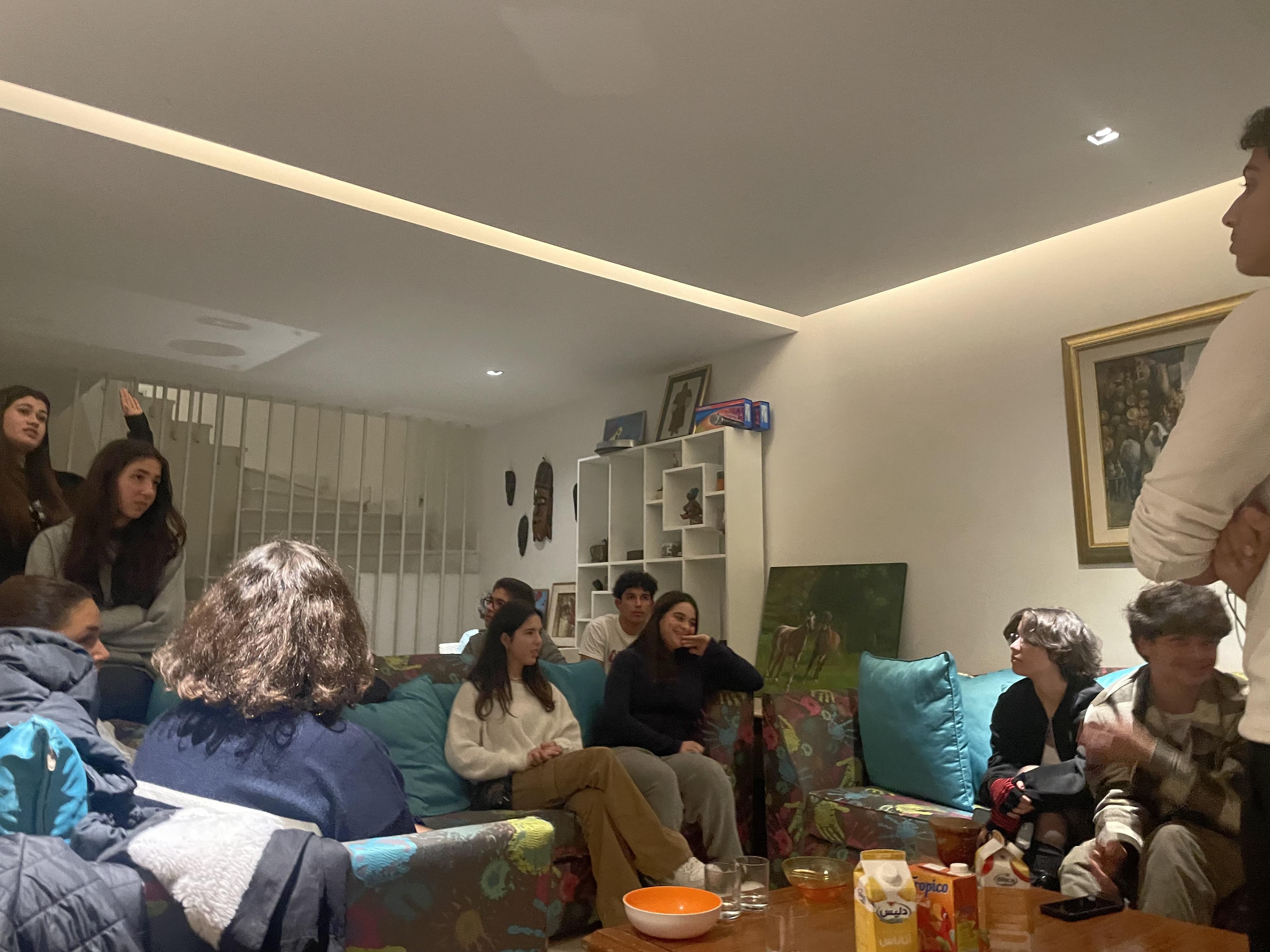 A group sitting together around a table in a living room.