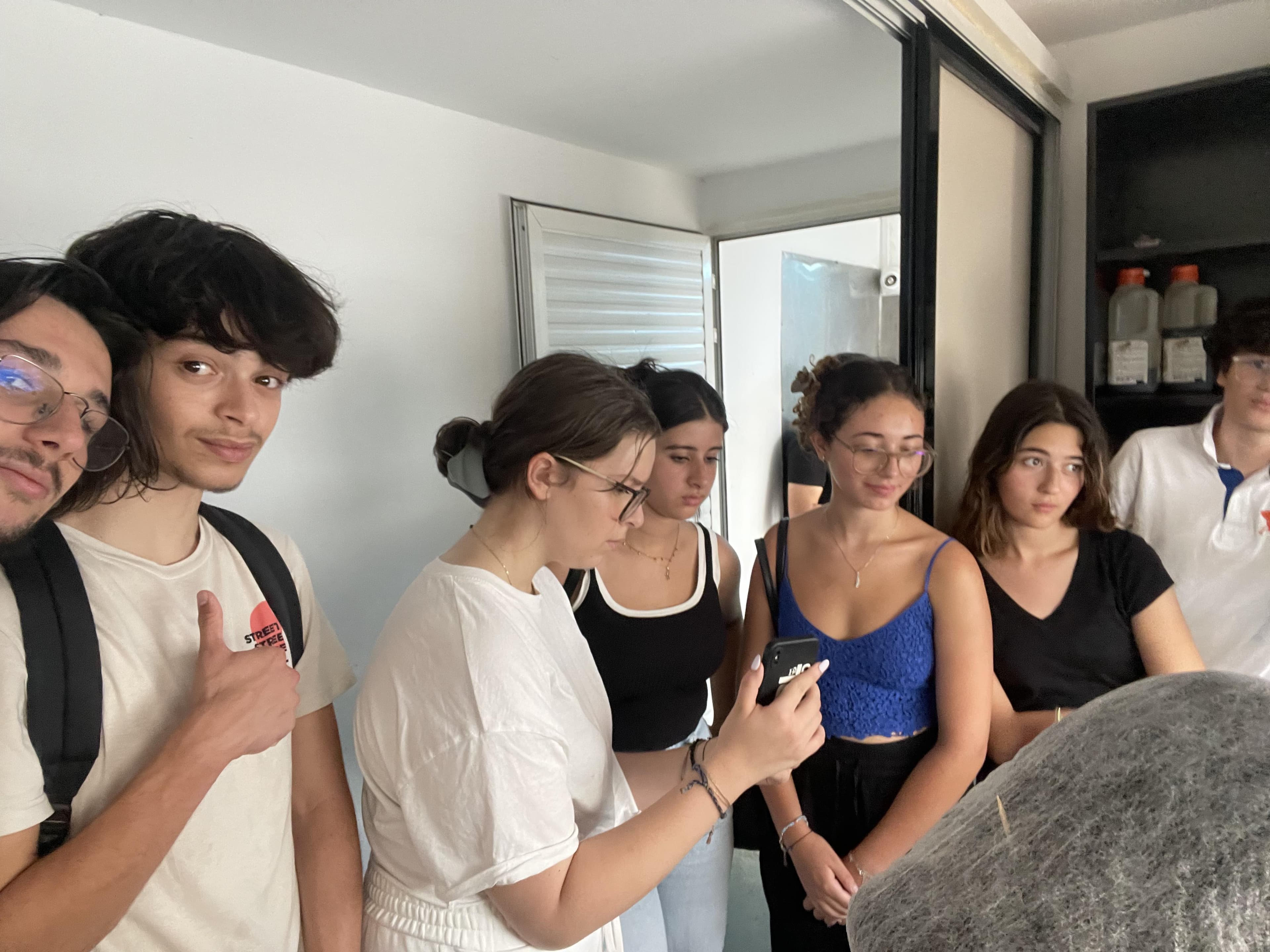 A group standing together beside an indoor table.