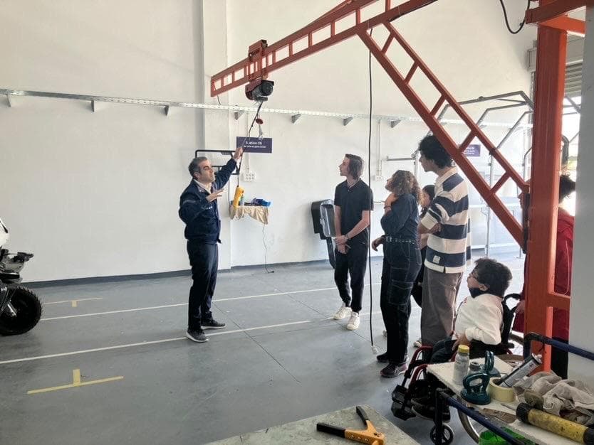 A group standing together in a workshop.