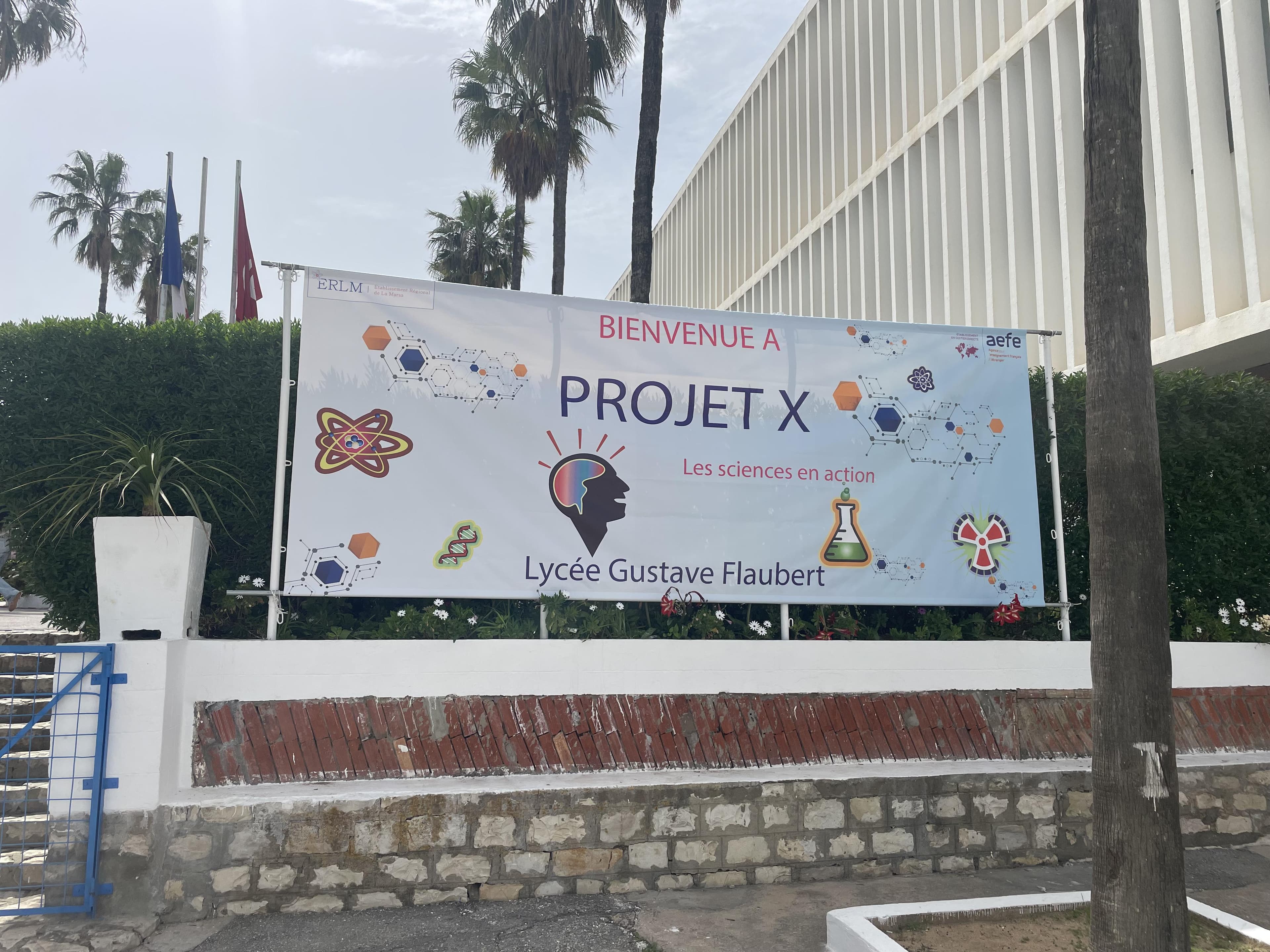 An outdoor banner beside a building.