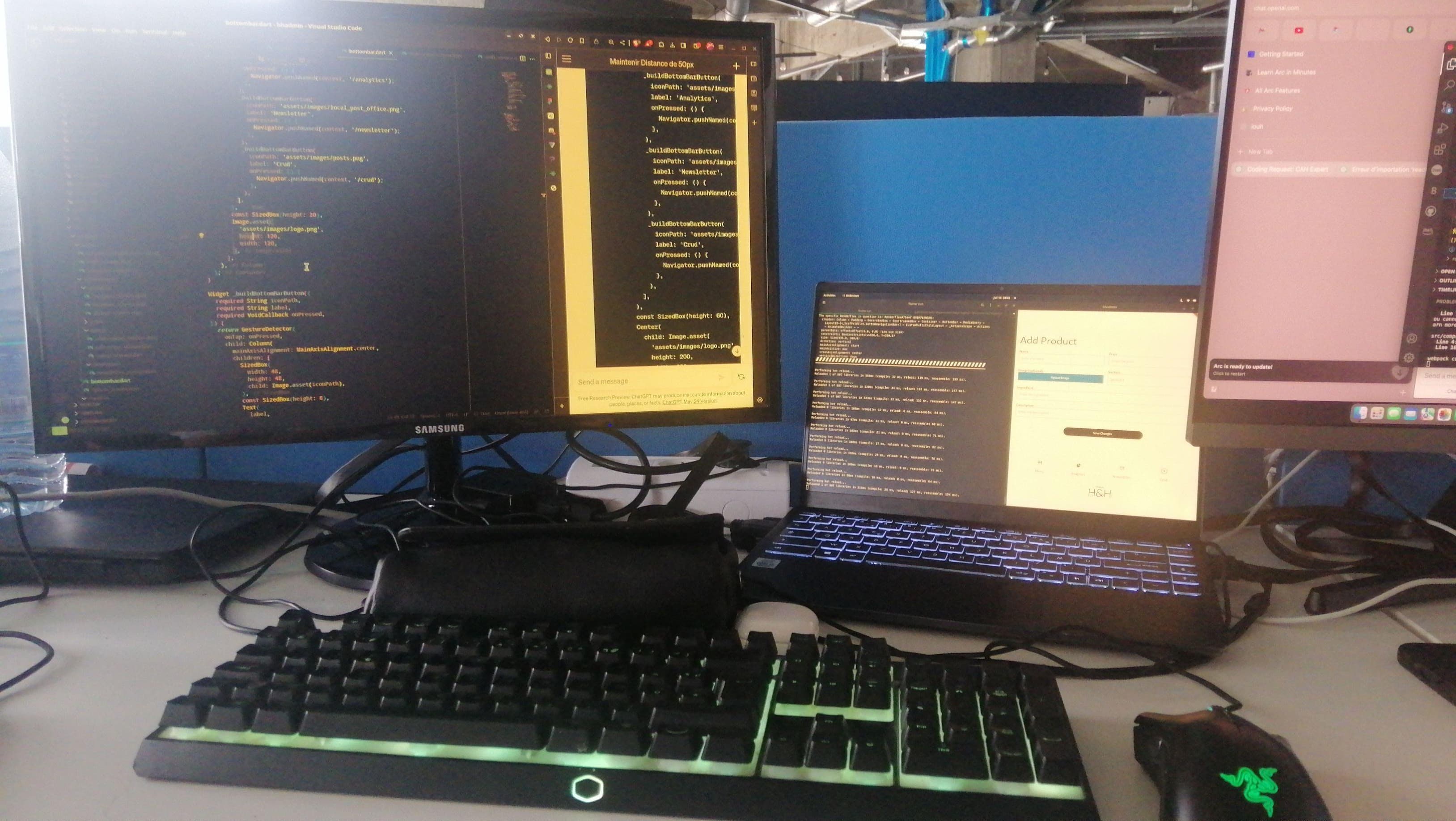 Multiple computer screens displaying code and an application interface.