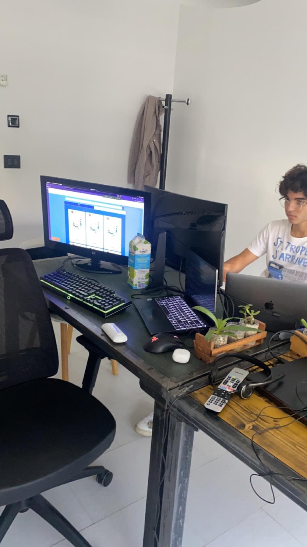 Computer screens and equipment on a shared desk.
